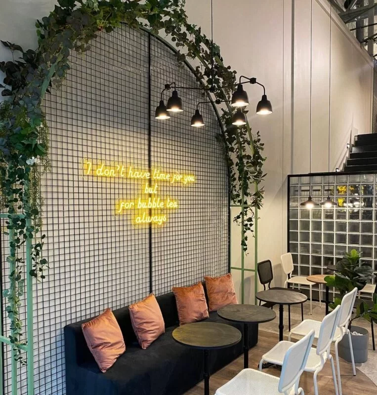 Yellow LED neon lettering on a café wall